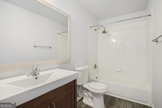 full bathroom with hardwood / wood-style floors, vanity, toilet, and shower / tub combination