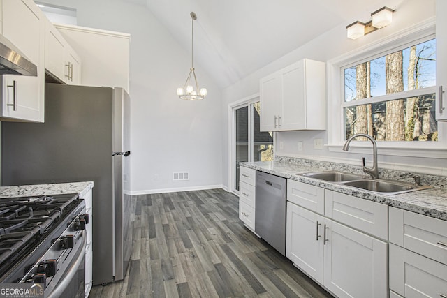 kitchen with sink, ventilation hood, vaulted ceiling, white cabinets, and appliances with stainless steel finishes