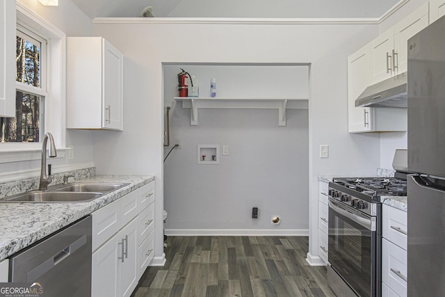 kitchen with light stone countertops, appliances with stainless steel finishes, dark hardwood / wood-style flooring, sink, and white cabinets