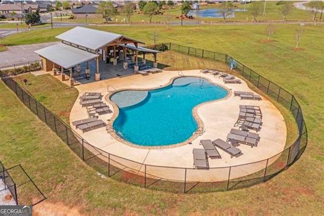 view of swimming pool with a yard and a patio