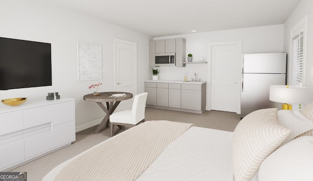 bedroom featuring white fridge and sink