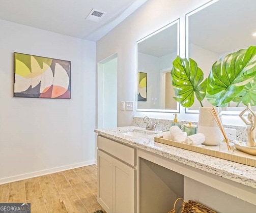 bathroom featuring vanity and hardwood / wood-style flooring