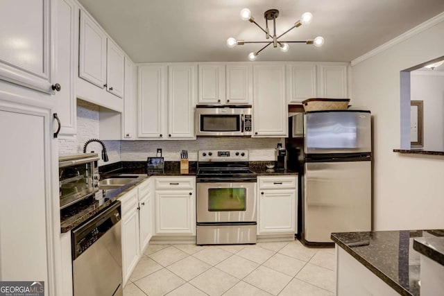 kitchen with appliances with stainless steel finishes, white cabinetry, crown molding, and sink