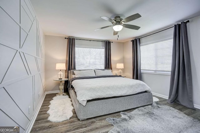 bedroom with ceiling fan and dark hardwood / wood-style floors