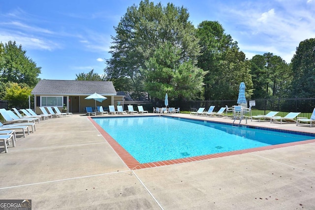 view of swimming pool featuring an outdoor structure and a patio area