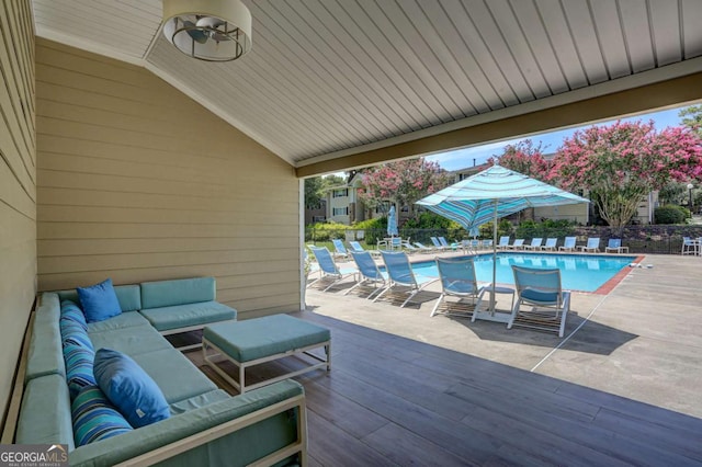 view of swimming pool with a wooden deck and an outdoor living space