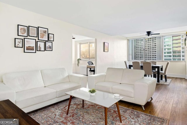 living room featuring hardwood / wood-style flooring and ceiling fan