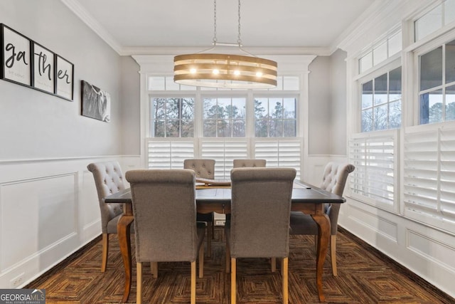 dining room with dark parquet flooring, crown molding, and a notable chandelier