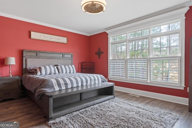 bedroom featuring dark wood-type flooring and ornamental molding