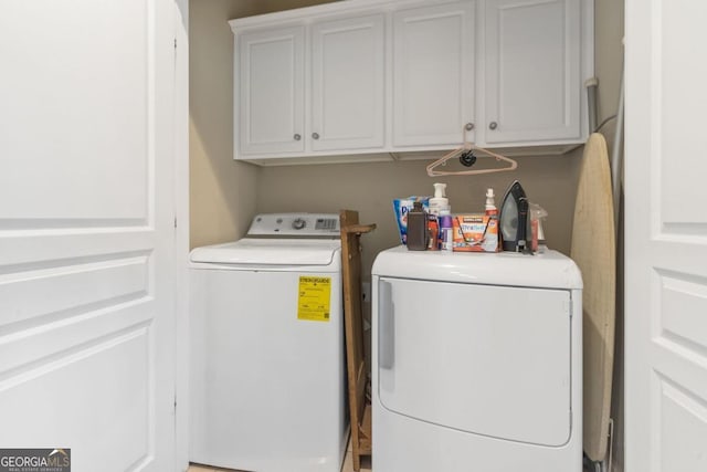 clothes washing area with cabinets and independent washer and dryer