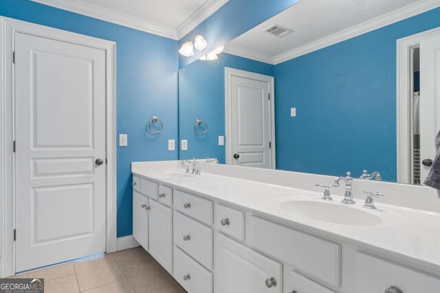 bathroom featuring tile patterned flooring, vanity, and ornamental molding