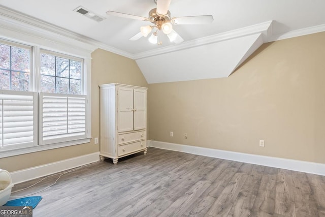 additional living space with ceiling fan, light hardwood / wood-style flooring, and vaulted ceiling