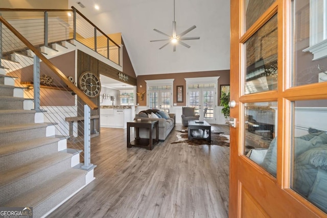 living room featuring ceiling fan, french doors, high vaulted ceiling, and wood-type flooring