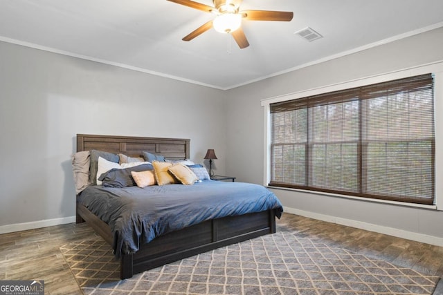 bedroom with ceiling fan, hardwood / wood-style floors, and ornamental molding