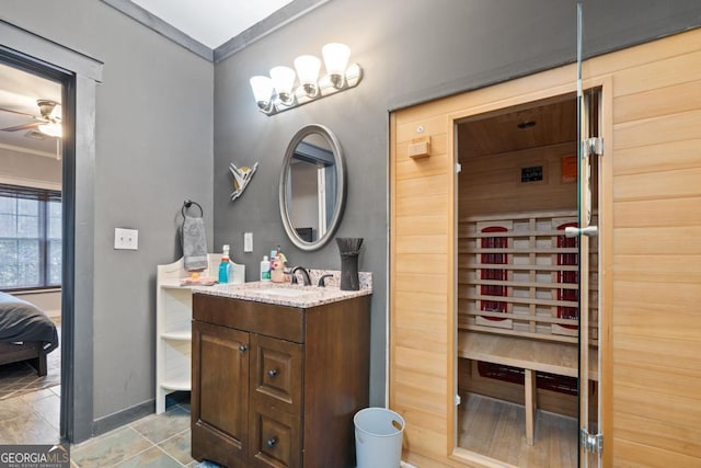 bathroom featuring ceiling fan, vanity, and ornamental molding