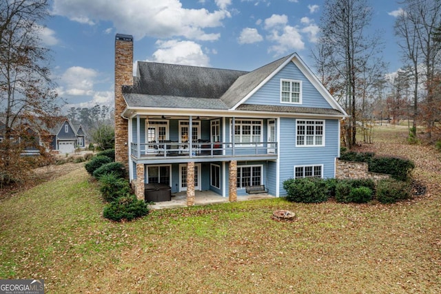 back of house with a yard, a patio, a fire pit, and a deck