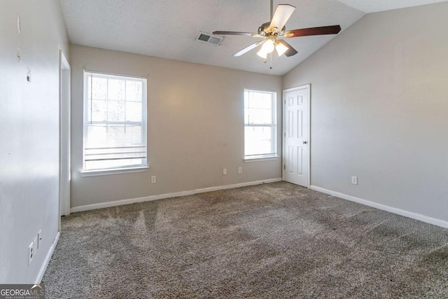 unfurnished room with a textured ceiling, ceiling fan, carpet, and lofted ceiling