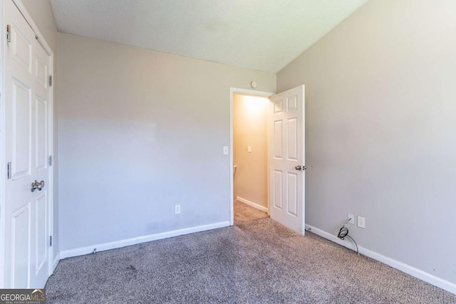 unfurnished bedroom with carpet and a textured ceiling