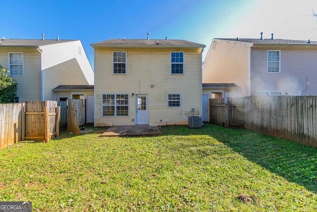 rear view of house featuring a lawn, a patio area, and central AC