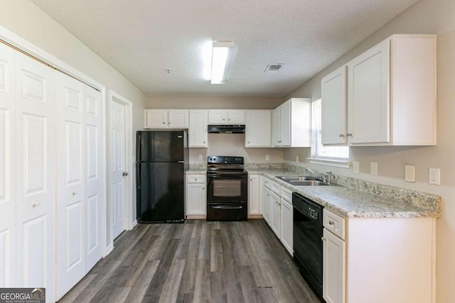 kitchen featuring a textured ceiling, sink, black appliances, white cabinets, and dark hardwood / wood-style floors