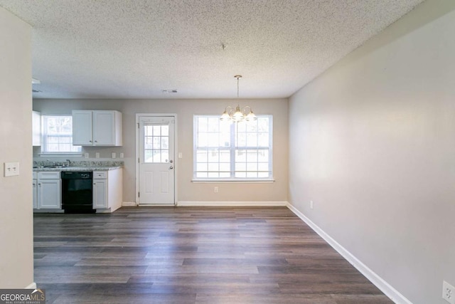 interior space with a chandelier, white cabinetry, dark wood-type flooring, and black dishwasher