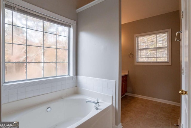 bathroom with a tub to relax in, tile patterned flooring, and vanity