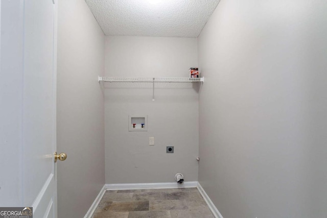 clothes washing area featuring electric dryer hookup, hookup for a washing machine, and a textured ceiling