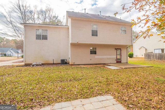 back of house featuring a yard, a patio, and central air condition unit