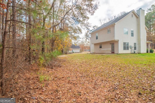 rear view of property featuring a yard