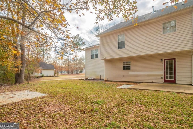 back of house with a patio area and a yard