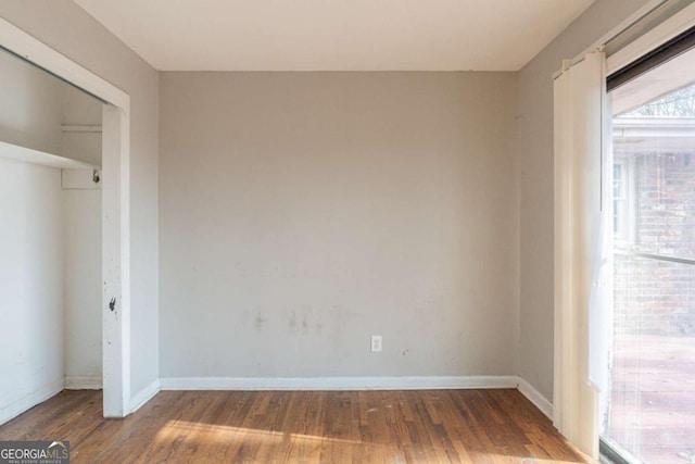 unfurnished bedroom featuring a closet and wood-type flooring