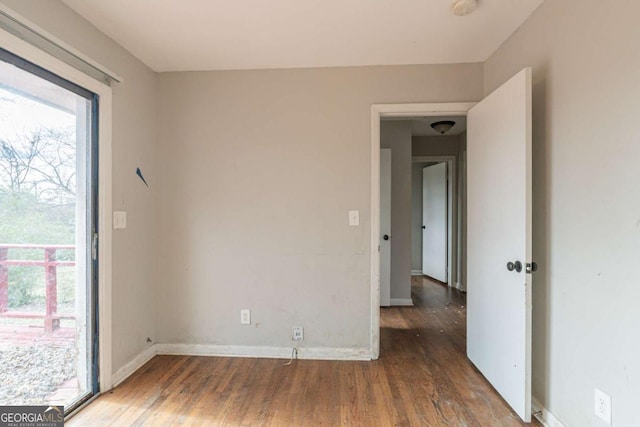 spare room featuring dark hardwood / wood-style flooring