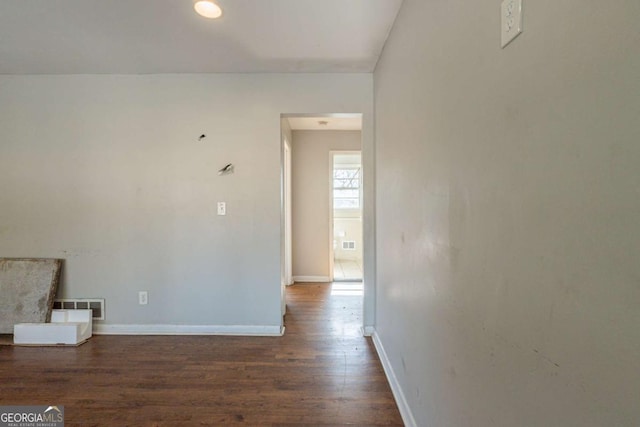 unfurnished living room featuring dark hardwood / wood-style flooring