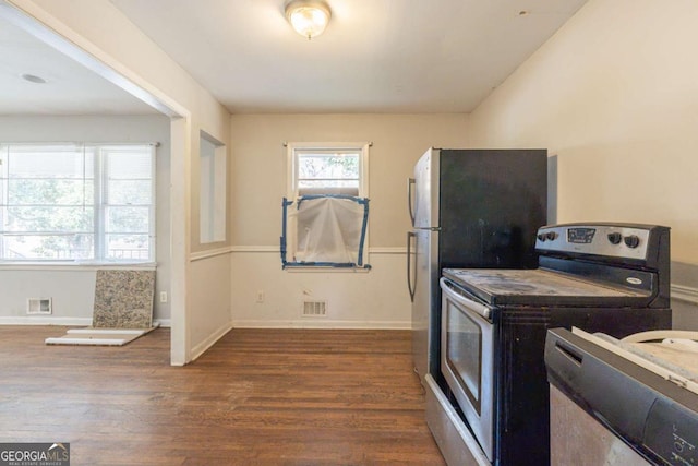 kitchen featuring dark wood-type flooring and stainless steel electric range