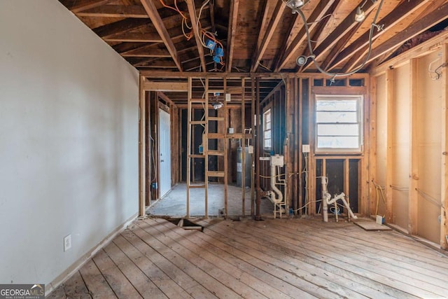 misc room with gas water heater and hardwood / wood-style flooring