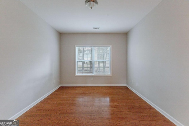 empty room with wood-type flooring