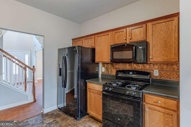 kitchen with backsplash and black appliances