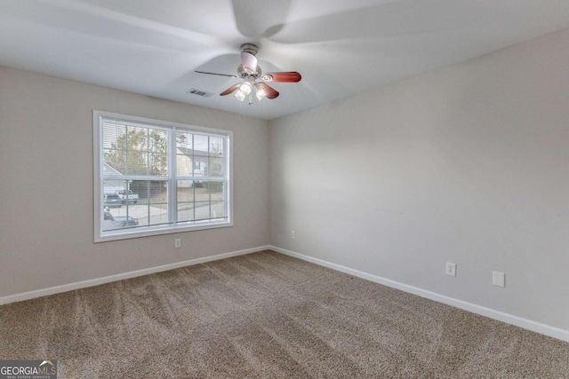 carpeted empty room featuring ceiling fan