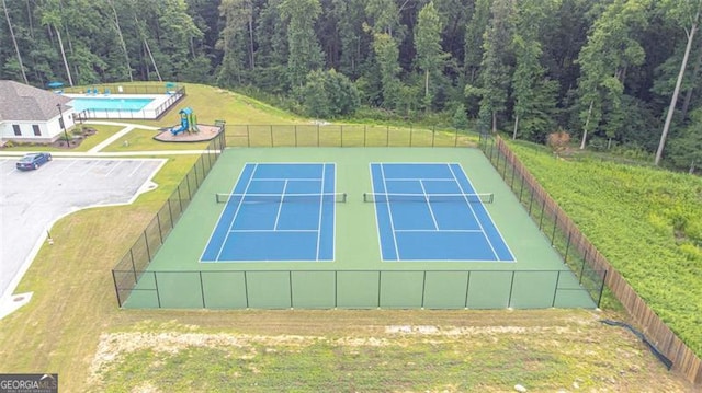 view of sport court with a yard