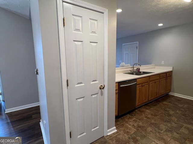 interior space with dishwasher, a textured ceiling, and sink