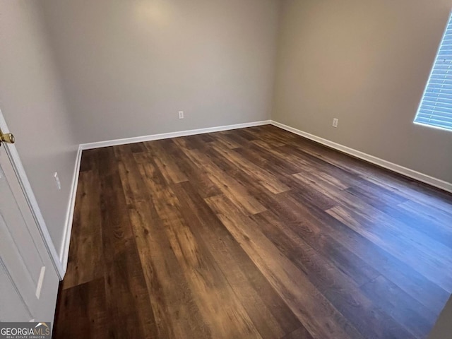 unfurnished room featuring dark hardwood / wood-style flooring