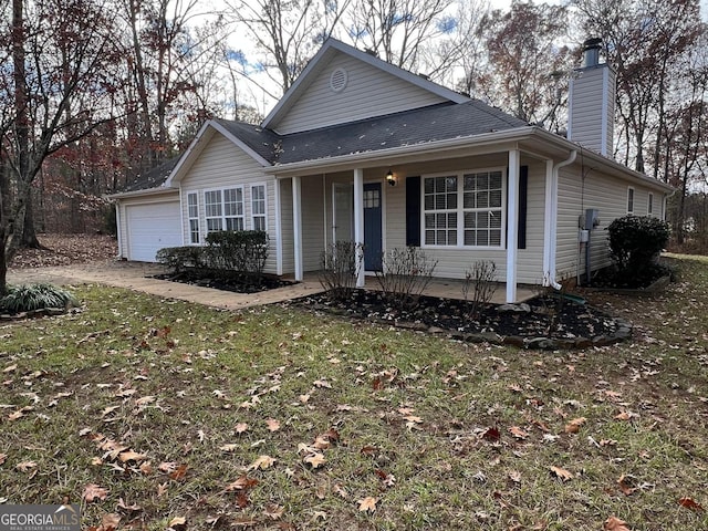 view of front of house with a front yard and a garage