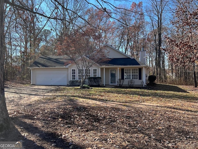 view of front of home with a front yard and a garage