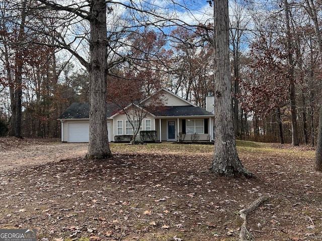 ranch-style home featuring covered porch and a garage