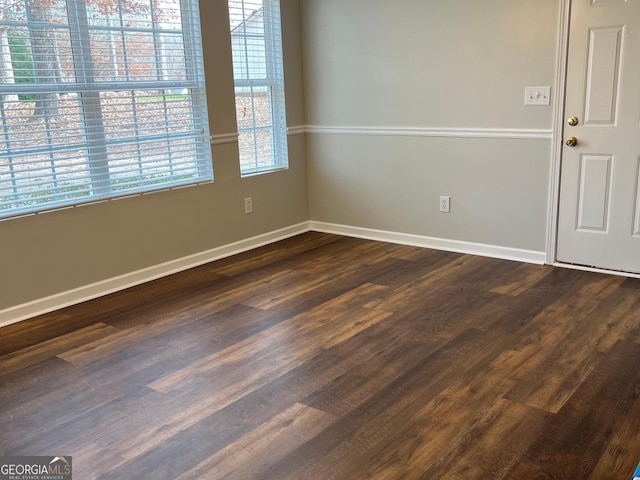 unfurnished room with dark hardwood / wood-style floors