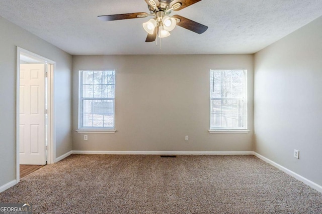 spare room featuring carpet flooring, ceiling fan, plenty of natural light, and a textured ceiling