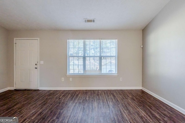 unfurnished room with dark hardwood / wood-style floors