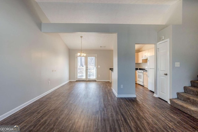 unfurnished living room featuring a chandelier and dark hardwood / wood-style floors