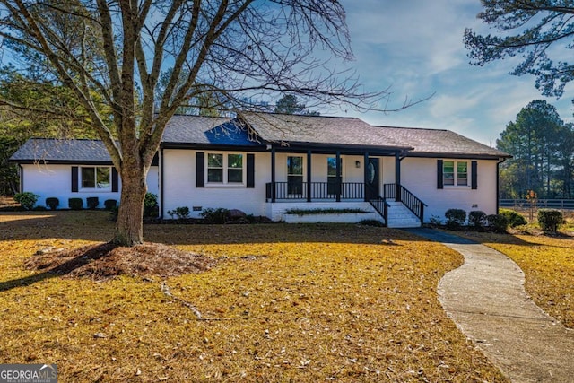 ranch-style house with brick siding, a front lawn, a porch, roof with shingles, and crawl space