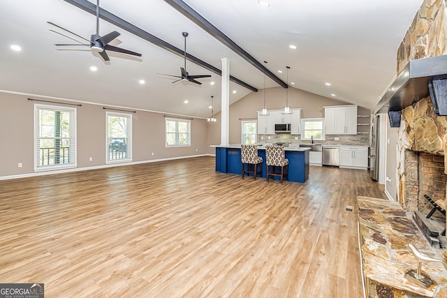 3625 Pointer Rd, Loganville, GA 30052 - unfurnished living room with a ceiling fan, light wood-style flooring, baseboards, recessed lighting, and a sink